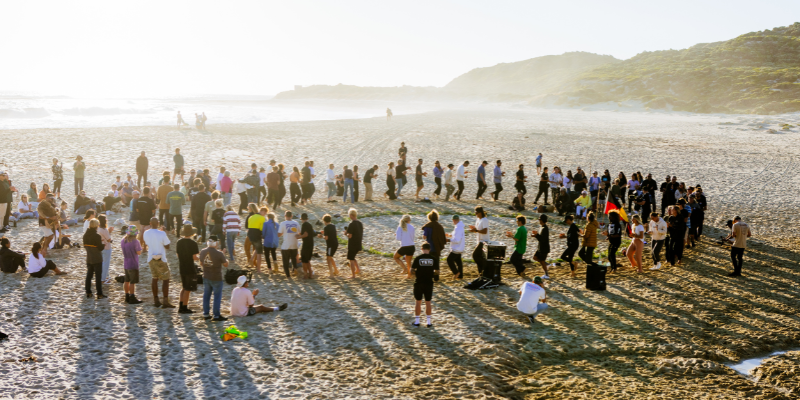 Image of ladies meditating on surfboards